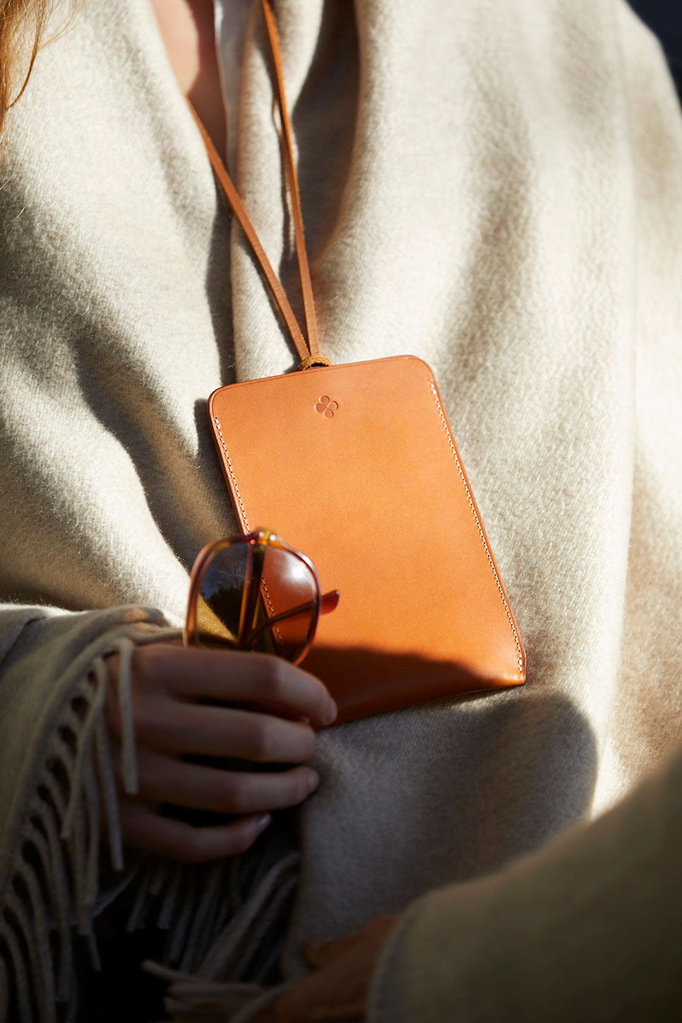tan leather phone case worn